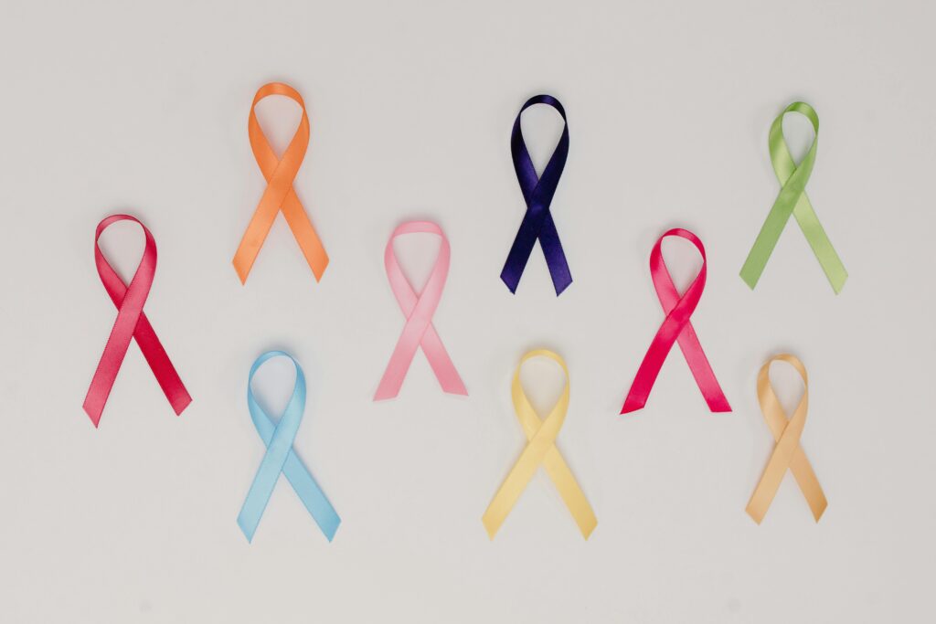 A collection of colorful awareness ribbons symbolizing various causes on a white background.